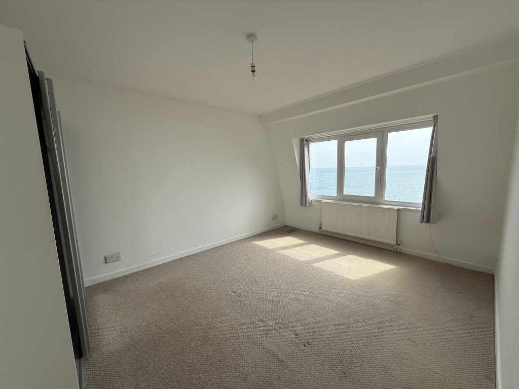 Lot: 124 - TOP FLOOR APARTMENT WITH STUNNING SEA VIEWS - Bedroom one and view of sea